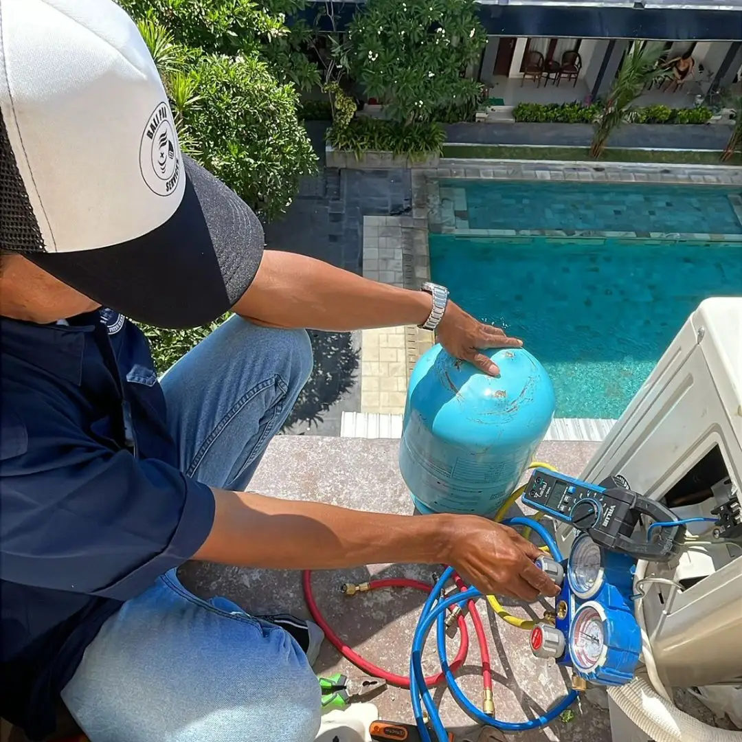 Technician using a thermal imaging camera to diagnose moisture in a villa wall