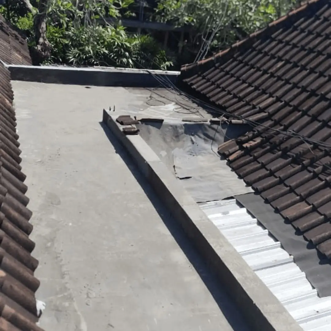 Perimeter drainage and ground grading away from a Bali villa wall