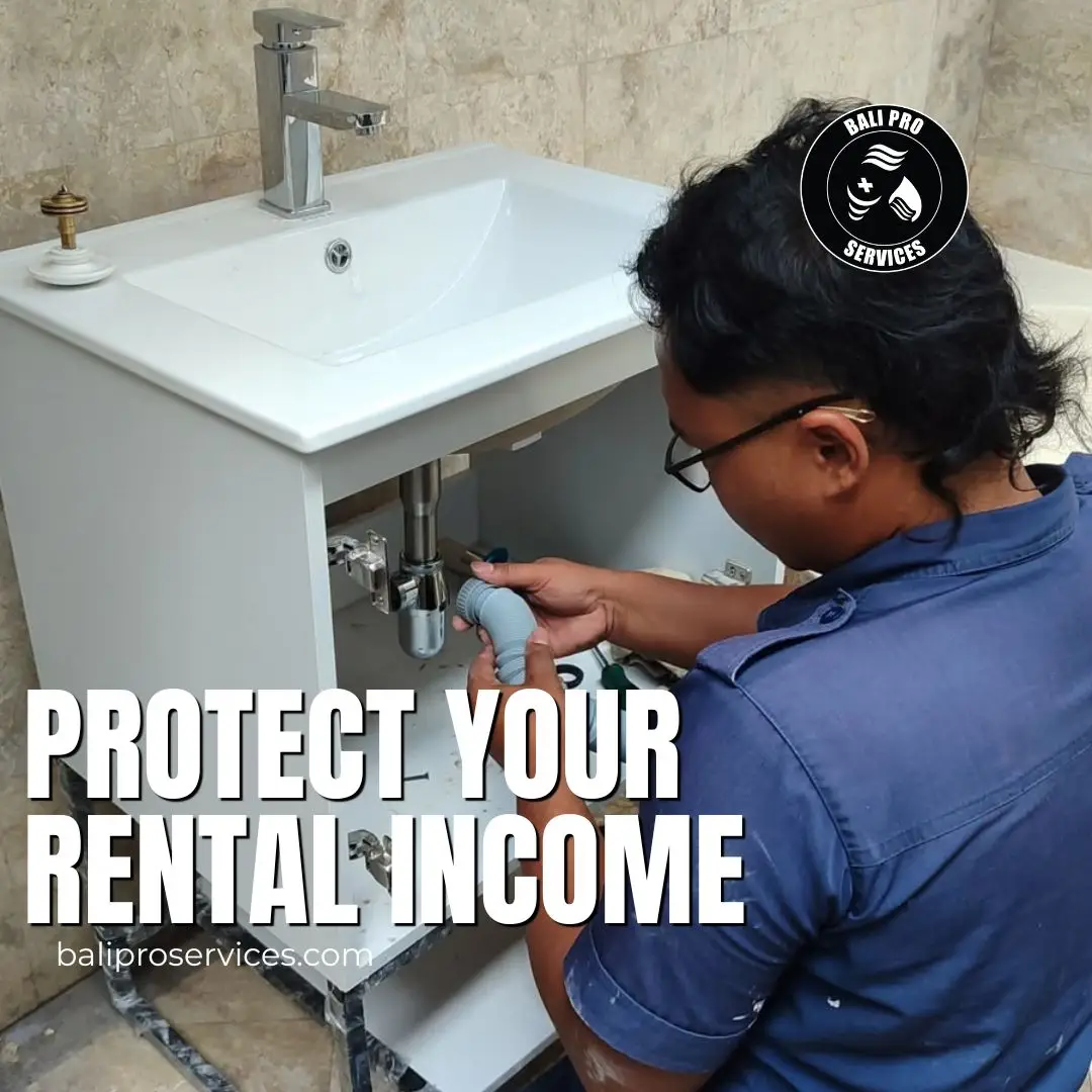 Technician performing preventative maintenance on a villa's AC unit in Bali