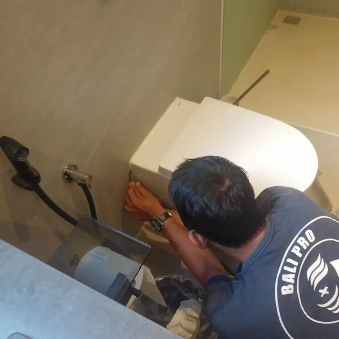 AC servicing and drainage check on a Bali rental property unit